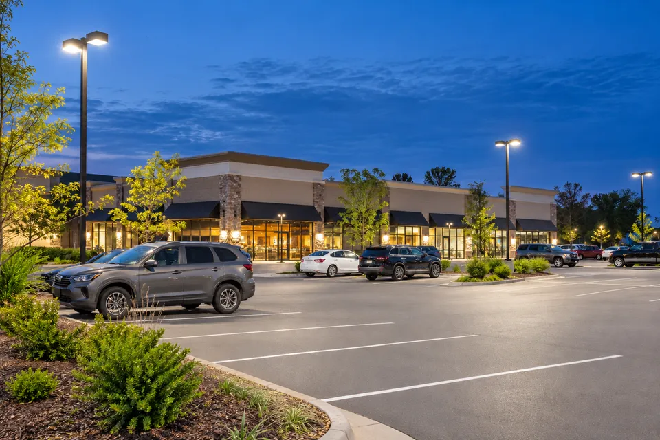 Evenly lit commercial parking area at blue hour